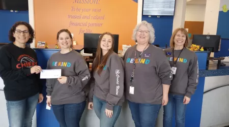 AAACU Team members taking a selfie as they clean up trash in their community
